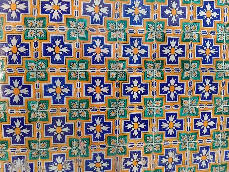 Glazed ceramic wall tiles with a repeating blue, green and orange pattern