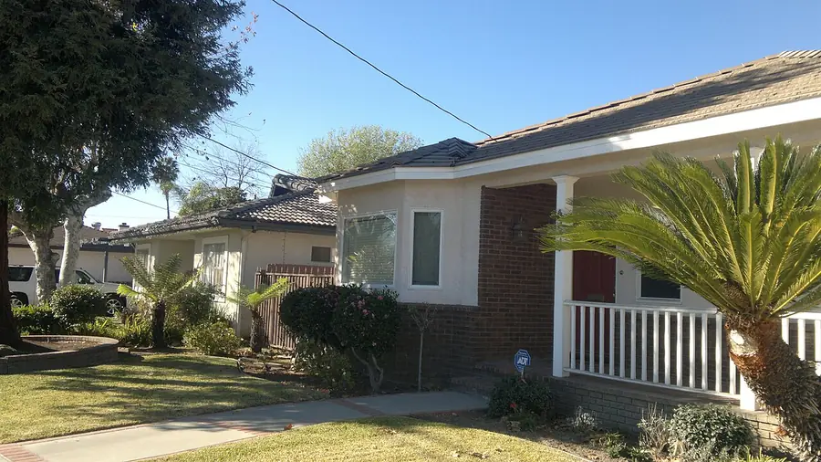 Single-story house with a porch and palm plant on a Temple City street