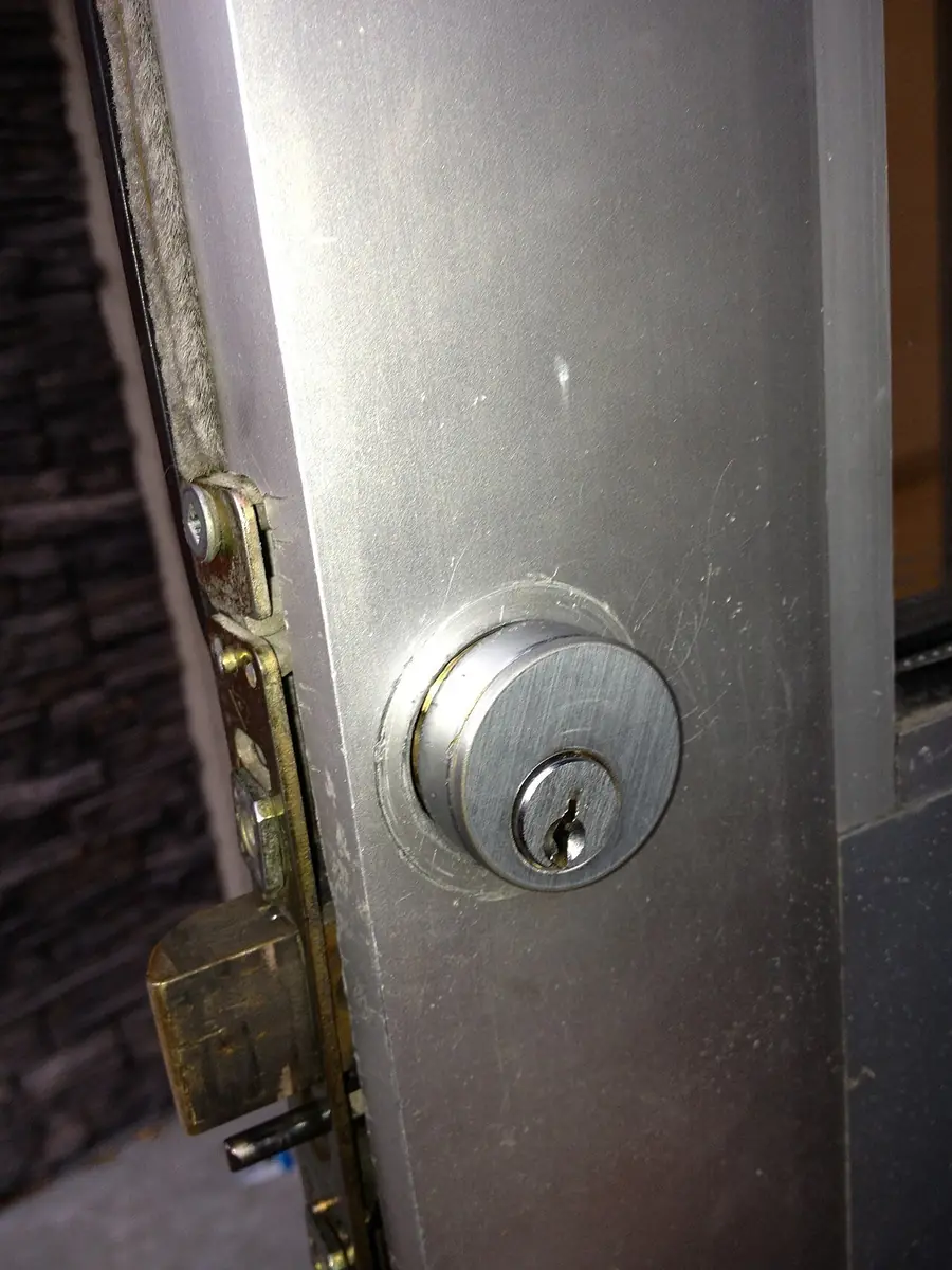 Mortise lock cylinder with a keyway set into a door, close up