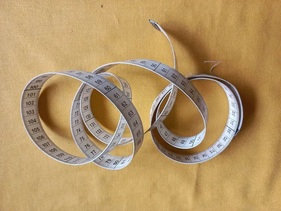 Rolled linen tailor's tape measure with numbers printed along it