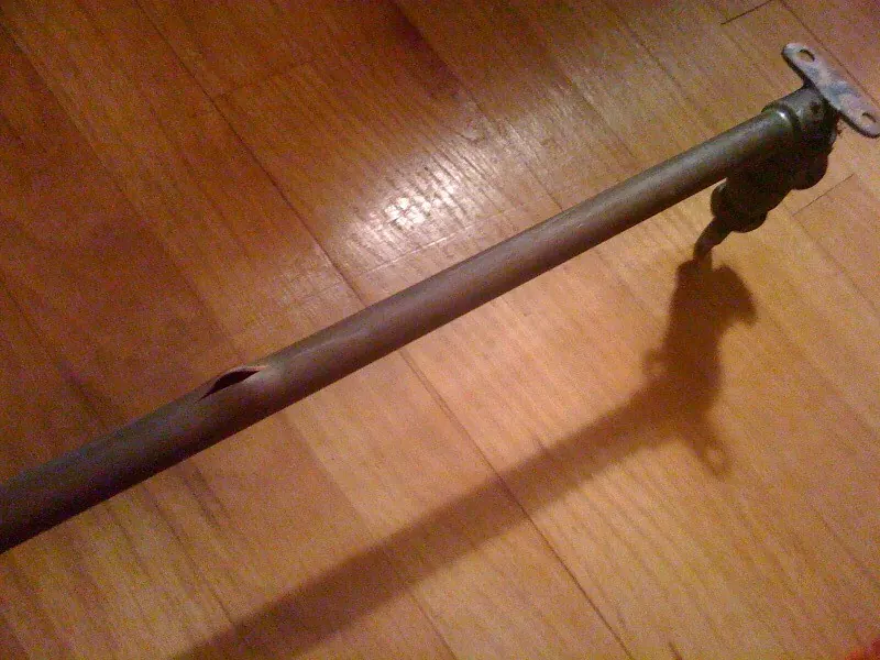 Section of metal water pipe with a corroded hole, removed after a leak