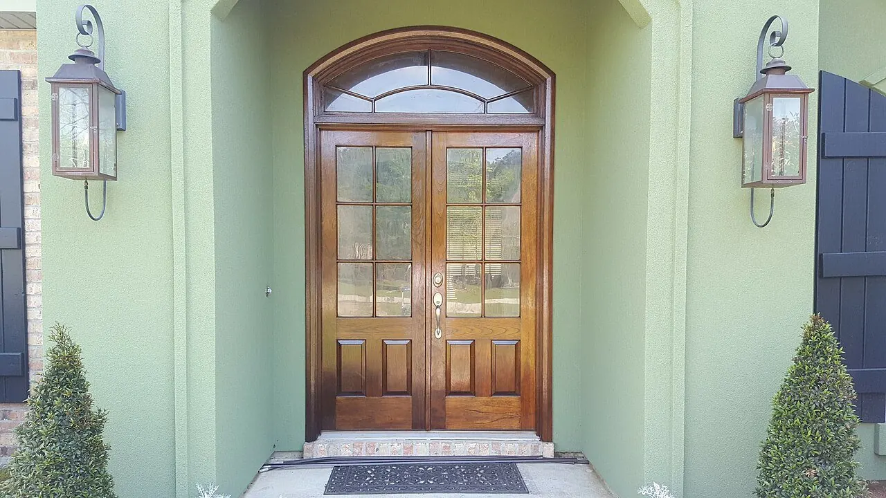 Wood front door with sidelights being refinished