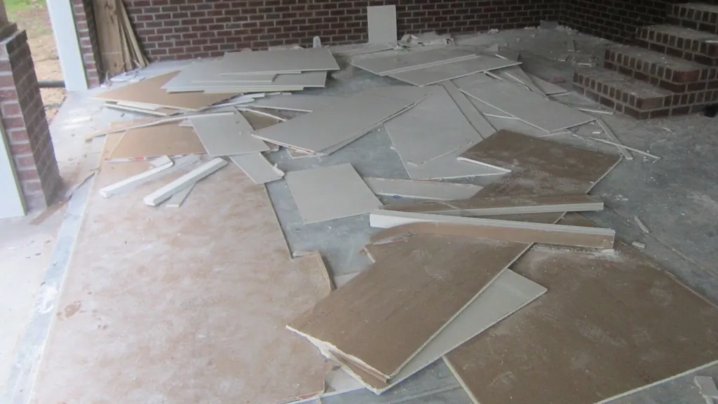 Pieces of broken drywall on a floor