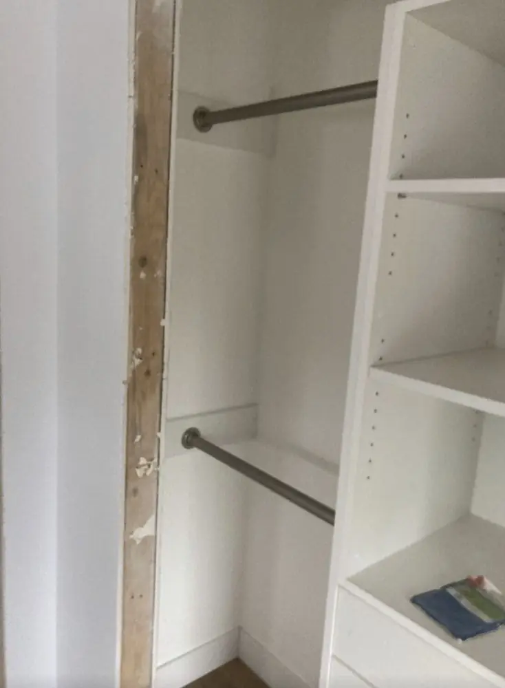 Closet with a new hanging rod and white shelving