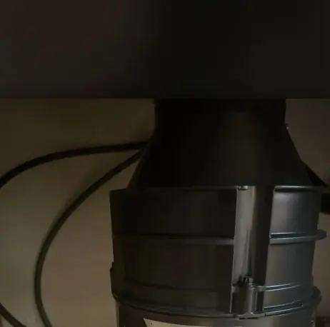 Underside of a garbage disposal showing the motor housing