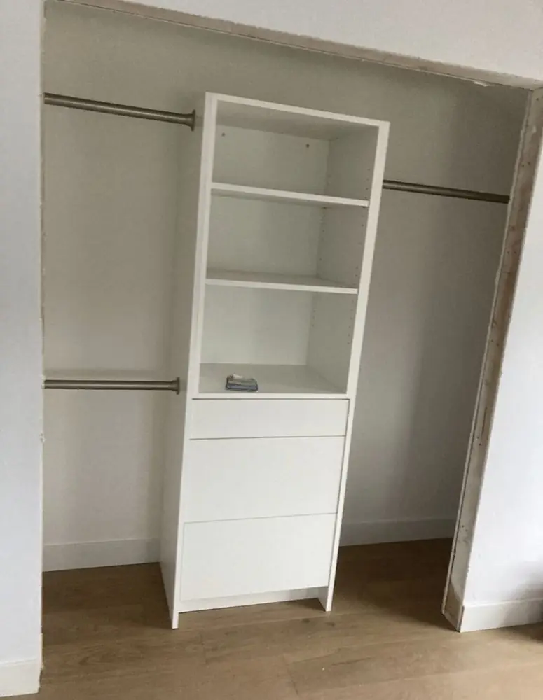 Closet organizer with shelves and a hanging rod