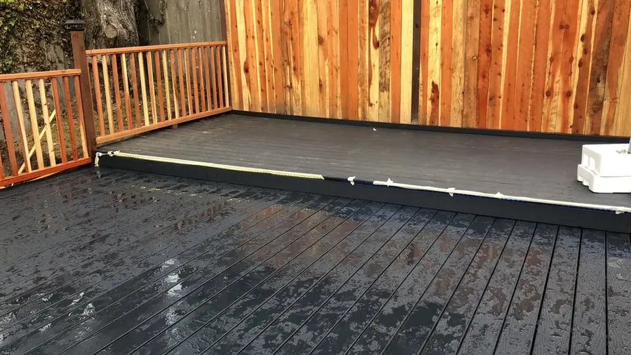 New wood deck with a fence along the back