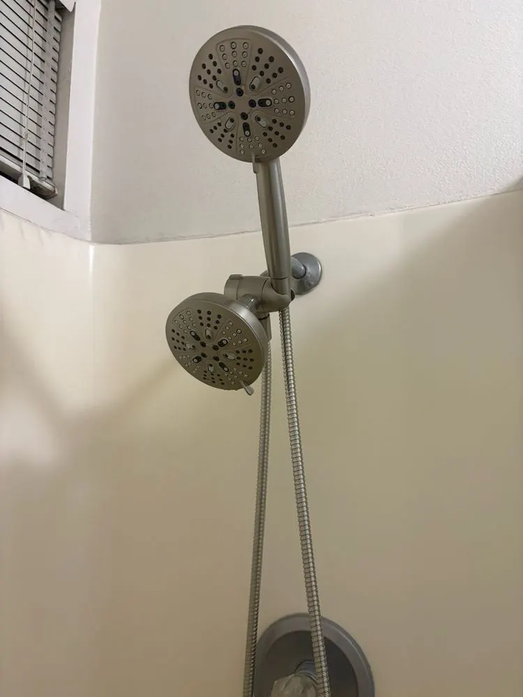 Handheld shower head on a slide bar mounted in a shower